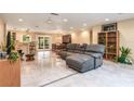 Open living area with gray sectional sofa and adjacent dining area at 8045 Happy Trl, Kissimmee, FL 34747