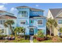 Two-story light blue house with balcony, shutters, and walkway at 8153 Surf St, Kissimmee, FL 34747