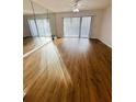 Bright living room with laminate floors and sliding doors at 8211 Sun Spring Cir # 42, Orlando, FL 32825