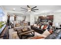 Open concept living room and kitchen with dark wood cabinetry and hardwood floors at 8407 Riverdale Ln, Davenport, FL 33896