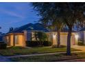 House exterior at night, showcasing landscaping and warm lighting at 8515 Sunrise Key Dr, Kissimmee, FL 34747