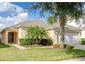 Single-story house with a palm tree and manicured lawn at 8515 Sunrise Key Dr, Kissimmee, FL 34747