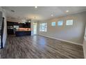 Open concept living and kitchen area with wood-look tile floors at 9121 Laureate Blvd, Orlando, FL 32827