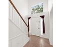 Bright entryway with staircase, tiled floor, and a large window at 942 Beresford Way, Lake Mary, FL 32746