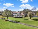 Luxury home on golf course with pool and lush landscaping at 9512 Tavistock Rd, Orlando, FL 32827