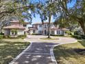 Luxury home with circular driveway and manicured landscaping at 9512 Tavistock Rd, Orlando, FL 32827