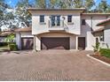 Three-car garage with brick paver driveway at 9512 Tavistock Rd, Orlando, FL 32827