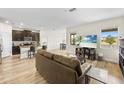 Bright open-plan living room with a large TV, comfortable sofa, and modern decor at 10060 Pecan Hickory Way, Orlando, FL 32832