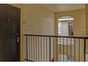 Condo hallway with dark door and metal railing at 102 Vista Verdi Cir # 320, Lake Mary, FL 32746