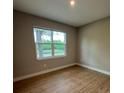Cozy bedroom with natural light, hardwood floors, and neutral paint at 116 E Cleveland St, Apopka, FL 32703