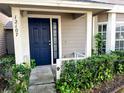 Home's entrance with navy blue door and landscaped walkway at 12107 Bruceton Way # 102, Orlando, FL 32828