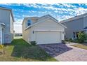 Two-story house with a two-car garage and a pond view at 1490 Woodmont Blvd, Kissimmee, FL 34746