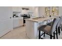 Modern kitchen with island, stainless steel appliances at 1542 Wax Myrtle Way, Haines City, FL 33844