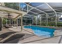 Inviting screened-in pool with lounge area and covered patio with ceiling fans for relaxing outdoor living at 1595 Stone Trl, Deltona, FL 32725