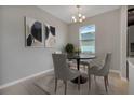 Dining area with four chairs and a neutral color scheme at 1682 Blue Lagoon Cir, Mascotte, FL 34753