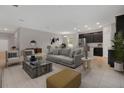 Open living room and kitchen with modern appliances and neutral colors at 1682 Blue Lagoon Cir, Mascotte, FL 34753