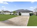 House exterior showcasing a white garage door and landscaping at 2841 Derby Dr, Deltona, FL 32738