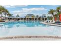 Resort-style community pool with lounge chairs and umbrellas at 297 Jetty Way, Davenport, FL 33897