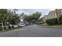 Gated community entrance with well-maintained landscaping and parking at 4145 Plantation Cove Dr, Orlando, FL 32810