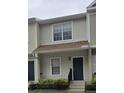 Two-story townhome with neutral siding and a brown roof at 4145 Plantation Cove Dr, Orlando, FL 32810