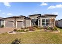 Two-story home with stone accents and three-car garage at 5599 Sw 92Nd Avenue Rd, Ocala, FL 34481
