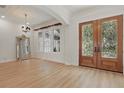 Bright and airy living room with wood floors, decorative mirror and detailed doorway at 6241 Blakeford Dr, Windermere, FL 34786