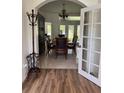 Elegant dining room with a chandelier, table, chairs, and french doors to let in natural light at 63 York Ct, Kissimmee, FL 34758