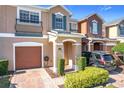 Two-story townhome with attached garage and landscaped front yard at 812 Park Grove Ct, Orlando, FL 32828
