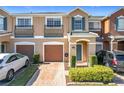 Two-story townhome with attached garage and landscaped front yard at 812 Park Grove Ct, Orlando, FL 32828