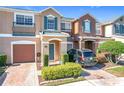 Two-story townhome with attached garage and landscaped front yard at 812 Park Grove Ct, Orlando, FL 32828