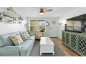 Light and airy living room features a comfy sofa and stylish decor at 830 Garfish Ave, New Smyrna Beach, FL 32169