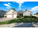 House exterior featuring stone, three-car garage, and solar panels at 863 Strathmore Dr, Orlando, FL 32803