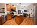 Spacious kitchen with granite island, stainless steel appliances, and hardwood floors at 863 Strathmore Dr, Orlando, FL 32803