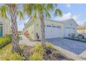 Two-story home with attached two-car garage and paved walkway at 906 Coral Reef Way, Daytona Beach, FL 32124