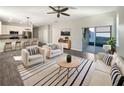 Open living area with modern furniture, tile floors, and access to a pool at 1162 Atlantic Ave, Fruitland Park, FL 34731