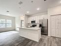 Modern kitchen with white cabinets and stainless steel appliances at 13566 Sw 79Th Terrace Rd, Ocala, FL 34473