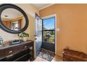 Bright entryway with a large mirror, console table, and a view to the front yard at 1435 Villa Ct, Deland, FL 32724