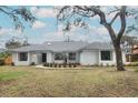 Updated home exterior boasts curb appeal with fresh landscaping at 1633 Cedar Glen Dr, Apopka, FL 32712