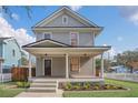 Two story craftsman home with a wrap-around porch and landscaped yard at 219 Laurel Ave, Sanford, FL 32771