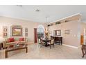 Elegant dining room with a chandelier, hardwood table, and beige walls at 3413 Foxcroft Cir, Oviedo, FL 32765