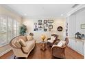 Sitting area with hardwood floors, wicker chairs, and a globe at 346 Calliope St, Ocoee, FL 34761