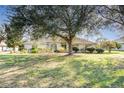 Single-story home with mature landscaping on a large lot at 36502 Barrington Dr, Eustis, FL 32736