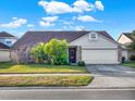 Single-story home with stone accents and a two-car garage at 388 Westwind Ct, Lake Mary, FL 32746