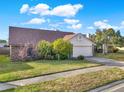 Single story home with stone exterior and attached garage at 388 Westwind Ct, Lake Mary, FL 32746