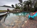 Relaxing pool with flagstone coping and waterfall feature at 4010 Winderlakes Dr, Orlando, FL 32835