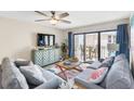Relaxing living room featuring two sofas and access to a balcony at 4175 S Atlantic Ave # 4070, New Smyrna Beach, FL 32169
