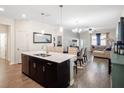 Open concept kitchen with island, stainless steel appliances, and white countertops at 4567 Tribute Trl, Kissimmee, FL 34746