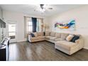 Spacious living room with large sectional sofa and wood-look flooring at 4567 Tribute Trl, Kissimmee, FL 34746