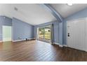 Bright living room with hardwood floors and large window at 4800 Pierce Arrow Dr, Apopka, FL 32712