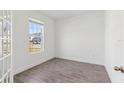 Bright bedroom with wood-look tile flooring and a large window offering a pleasant view at 5000 Northern Dove Ave, Mount Dora, FL 32757